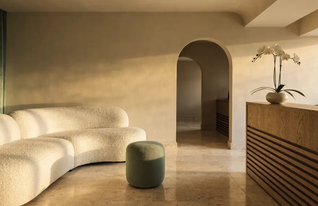 Juniper's reception lounge with a curved cream sofa