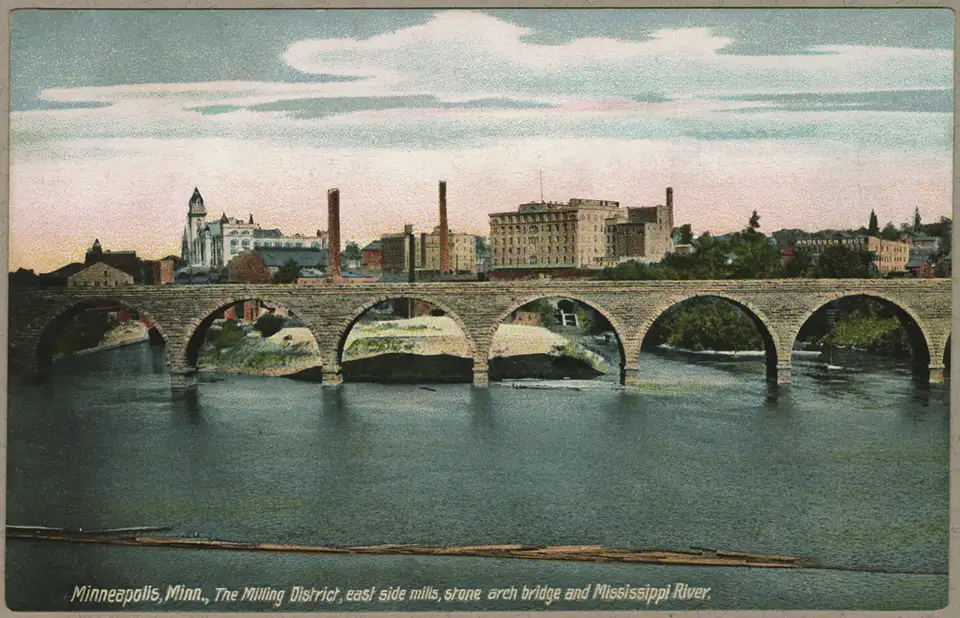 A 1906 postcard of the Stone Arch Bridge, the river and the mills on the east bank