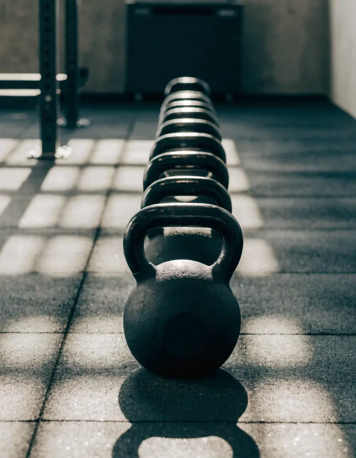 Kettlebells lined up on the rubber floor