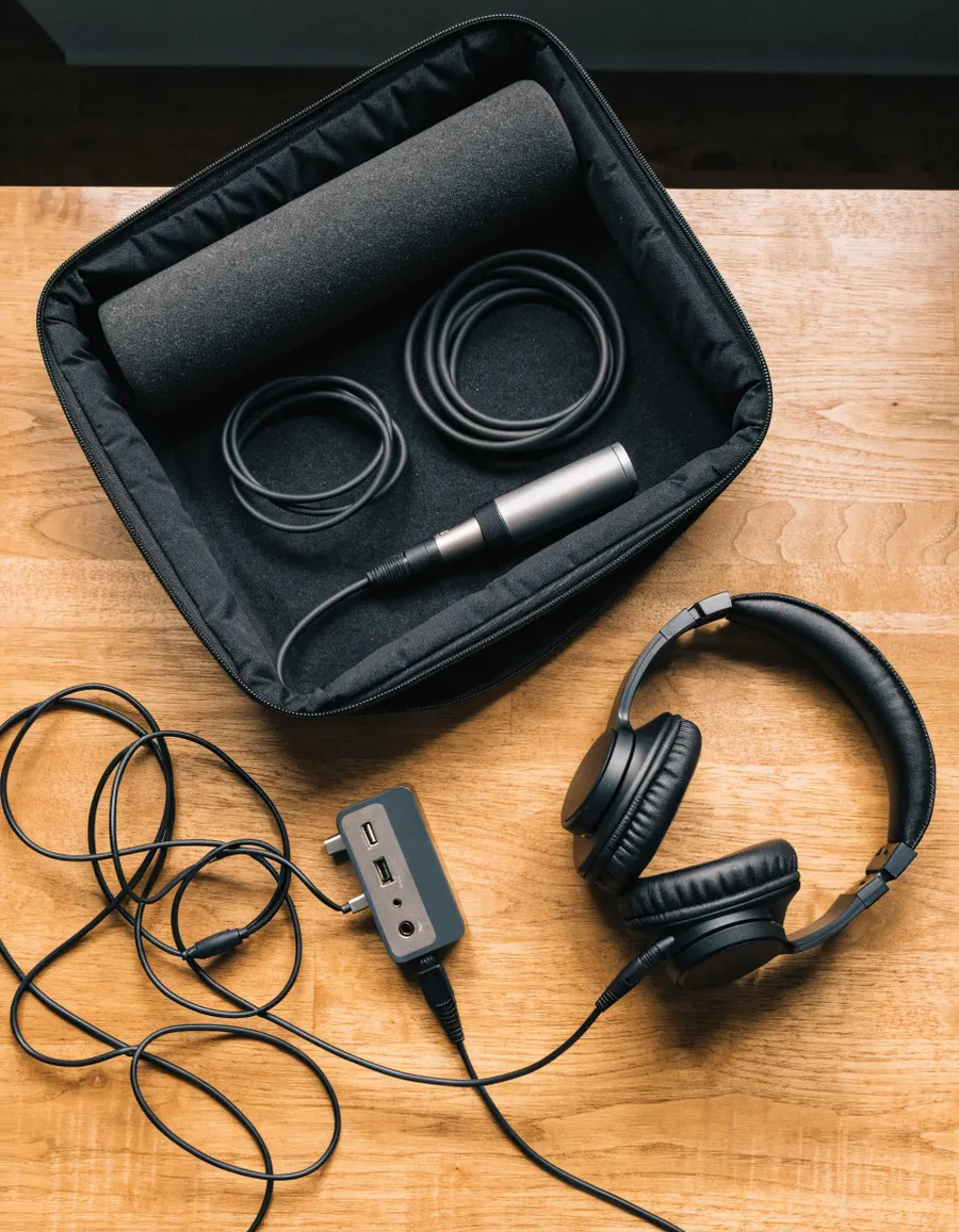 The remote recording kit: a microphone, headphones and cables in a padded case