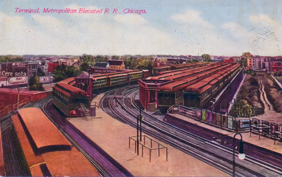 A coloured postcard of the Logan Square elevated terminal around 1910, trains under red roofs